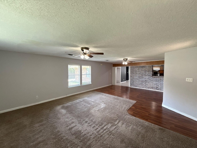 137 W 6th St, Krum, TX 76249 - unfurnished living room featuring carpet, a ceiling fan, baseboards, a textured ceiling, and wood finished floors