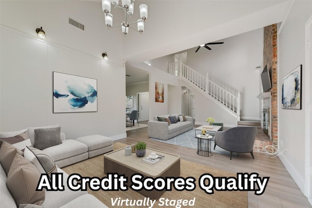 1102 Dandelion Dr, Mesquite, TX 75149 - living area with a towering ceiling, stairway, light wood-style floors, a chandelier, and baseboards