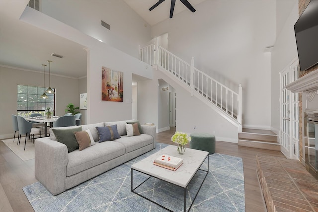 1102 Dandelion Dr, Mesquite, TX 75149 - living room with stairway, ceiling fan, wood finished floors, baseboards, and a high ceiling