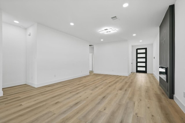 3923 Le May Ave, Dallas, TX 75216 - empty room featuring recessed lighting, a fireplace, light wood-style floors, and baseboards