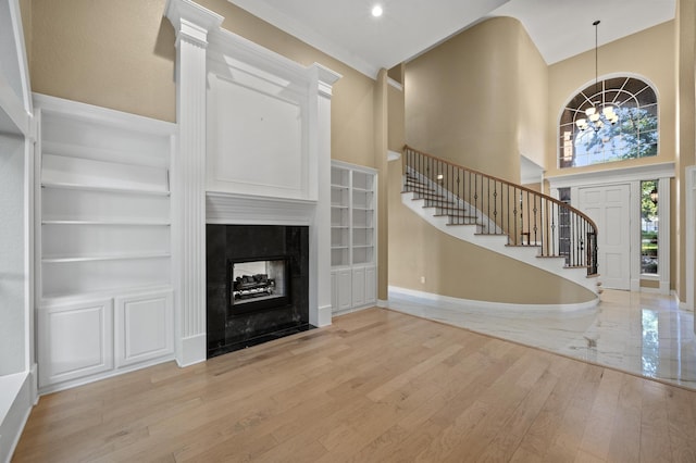 1002 Hidden Knoll Ct, Southlake, TX 76092 - foyer entrance with a chandelier, stairs, a towering ceiling, light wood finished floors, and a tile fireplace