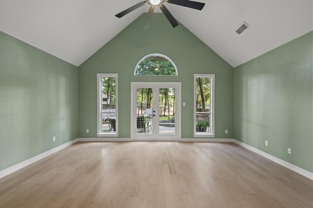 1002 Hidden Knoll Ct, Southlake, TX 76092 - unfurnished living room featuring a ceiling fan, high vaulted ceiling, plenty of natural light, light wood-style flooring, and french doors