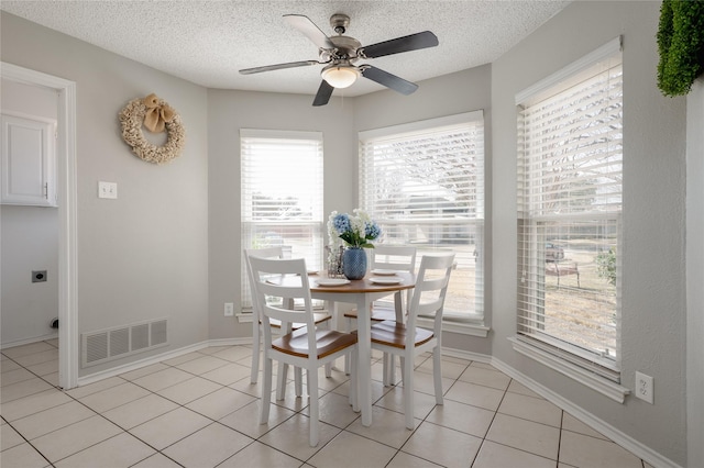 437 Country Side Ln, Richardson, TX 75081 - dining room with a textured ceiling, ceiling fan, and light tile patterned floors