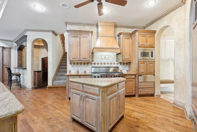 9922 Lakeway Ct, Dallas, TX 75230 - kitchen with custom exhaust hood, range, stainless steel microwave, a ceiling fan, and a warming drawer