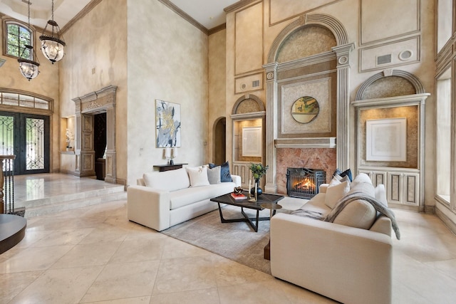 9922 Lakeway Ct, Dallas, TX 75230 - living area with a towering ceiling, a premium fireplace, baseboards, crown molding, and a chandelier
