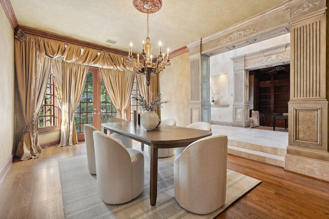 9922 Lakeway Ct, Dallas, TX 75230 - dining space with ornate columns, a chandelier, crown molding, wood finished floors, and baseboards