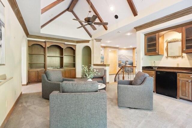 9922 Lakeway Ct, Dallas, TX 75230 - living area with wet bar, light colored carpet, beam ceiling, baseboards, and a ceiling fan