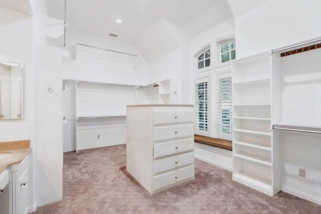9922 Lakeway Ct, Dallas, TX 75230 - walk in closet with light carpet and lofted ceiling