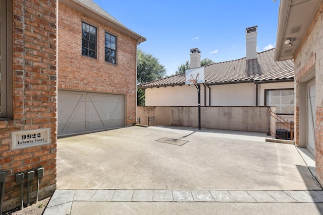 9922 Lakeway Ct, Dallas, TX 75230 - view of patio featuring an attached garage