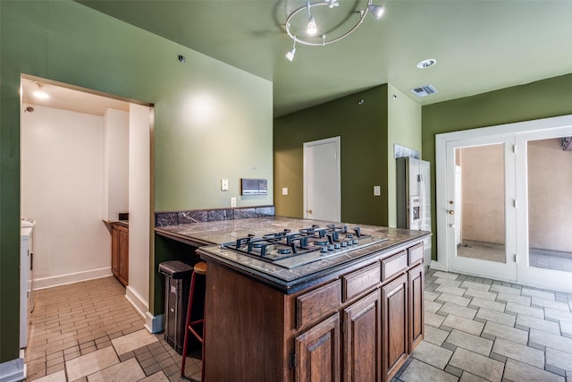 905 Liberty St, Dallas, TX 75204 - kitchen with dark countertops, stainless steel gas stovetop, and baseboards