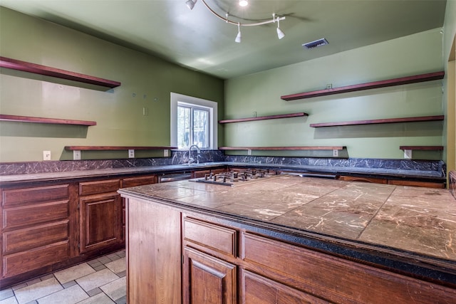 905 Liberty St, Dallas, TX 75204 - kitchen featuring open shelves, dark countertops, a sink, stainless steel dishwasher, and gas stovetop