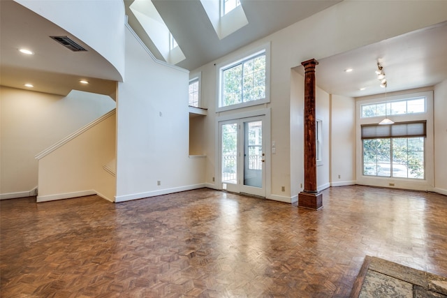 905 Liberty St, Dallas, TX 75204 - unfurnished living room with a high ceiling, baseboards, recessed lighting, and decorative columns