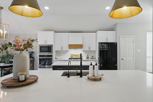 15429 Calico Ct, Frisco, TX 75035 - kitchen featuring freestanding refrigerator, oven, built in microwave, tasteful backsplash, and light countertops