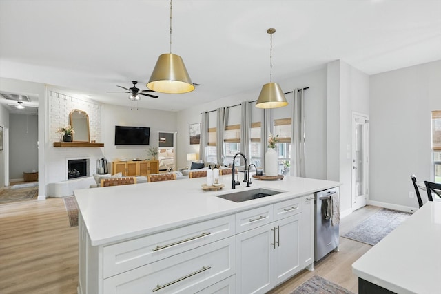 15429 Calico Ct, Frisco, TX 75035 - kitchen with a sink, dishwasher, a kitchen island with sink, a ceiling fan, and light countertops