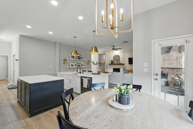 15429 Calico Ct, Frisco, TX 75035 - dining space with light wood-style floors, a ceiling fan, and a chandelier
