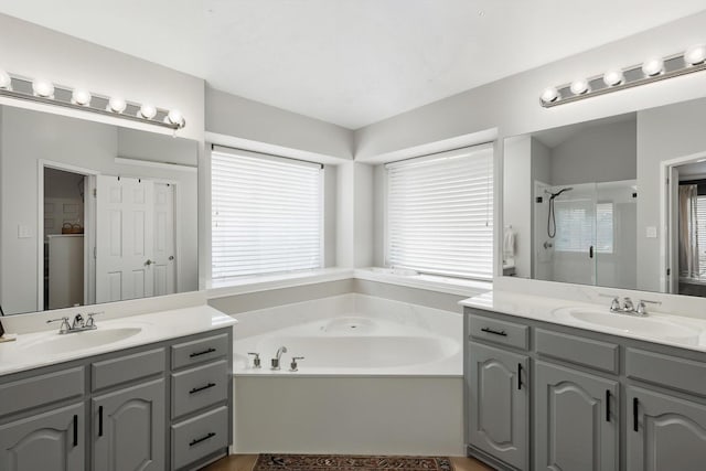 15429 Calico Ct, Frisco, TX 75035 - full bathroom with a garden tub, two vanities, and a stall shower