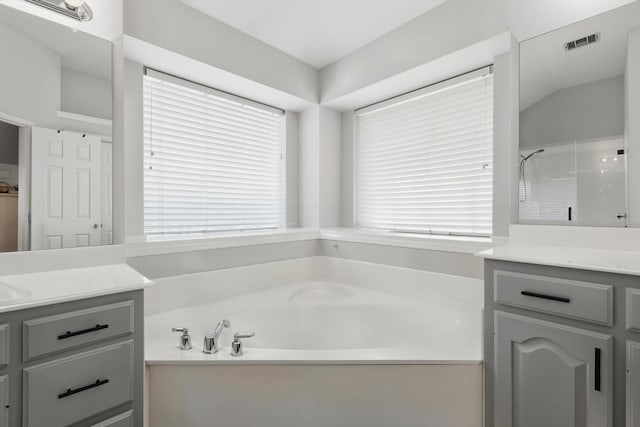 15429 Calico Ct, Frisco, TX 75035 - full bathroom with vanity, a garden tub, healthy amount of natural light, and a shower
