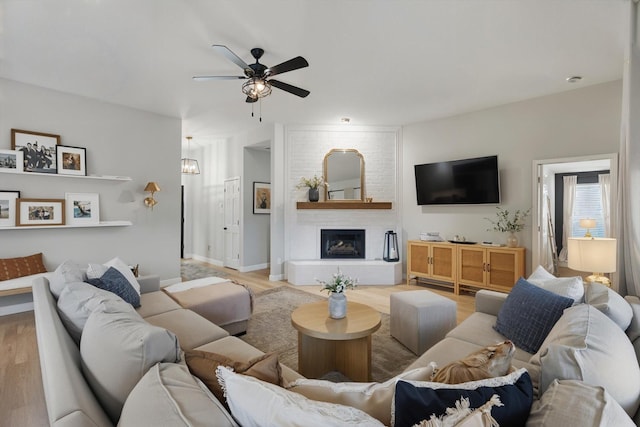 15429 Calico Ct, Frisco, TX 75035 - living room featuring ceiling fan, wood finished floors, and a fireplace