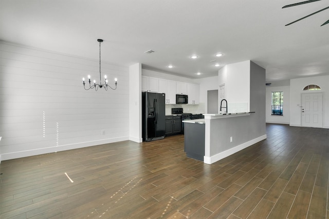 3013 Flowering Springs Dr, Forney, TX 75126 - kitchen featuring black appliances, baseboards, dark wood-style flooring, a peninsula, and open floor plan