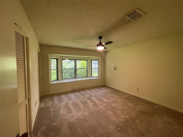 310 Lancashire Dr, Bossier City, LA 71111 - spare room with carpet, ceiling fan, baseboards, and a textured ceiling