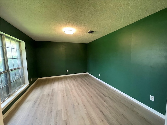 310 Lancashire Dr, Bossier City, LA 71111 - spare room featuring wood finished floors, a textured ceiling, and baseboards