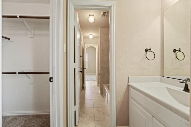 14759 Huffman Ln, Frisco, TX 75035 - bathroom with vanity, a walk in closet, and a bathtub