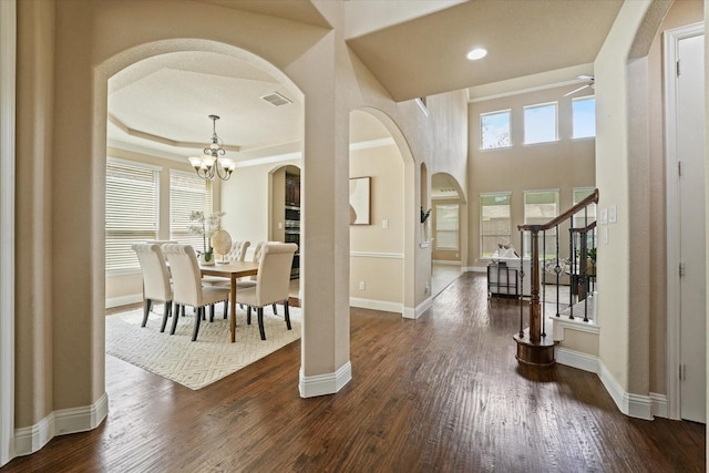 14759 Huffman Ln, Frisco, TX 75035 - foyer entrance featuring arched walkways, stairway, dark wood-type flooring, a chandelier, and recessed lighting