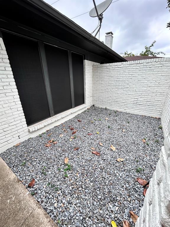 100 Trellis Pl Unit 102, Richardson, TX 75081 - view of side of property with brick siding and a chimney
