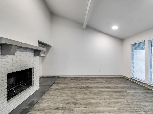 100 Trellis Pl Unit 102, Richardson, TX 75081 - unfurnished living room with lofted ceiling, wood finished floors, baseboards, a brick fireplace, and recessed lighting