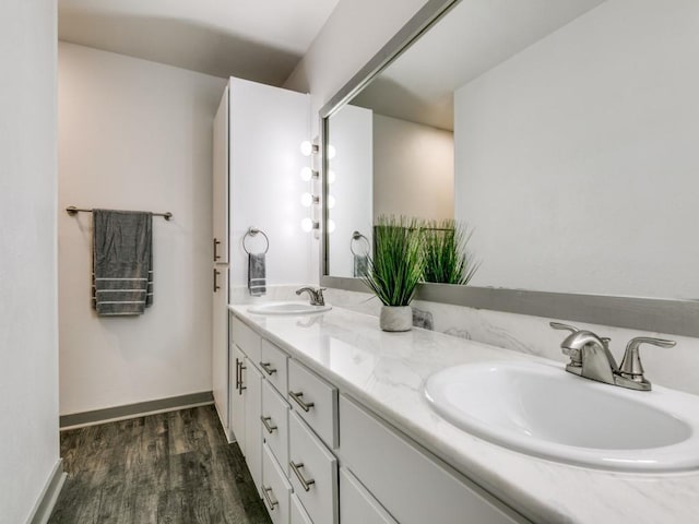 100 Trellis Pl Unit 102, Richardson, TX 75081 - bathroom featuring double vanity, wood finished floors, and baseboards