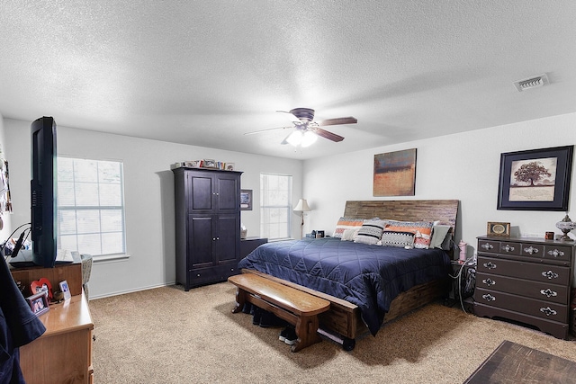 5730 Rendon Estates Rd, Mansfield, TX 76063 - bedroom with light carpet, multiple windows, a textured ceiling, and a ceiling fan