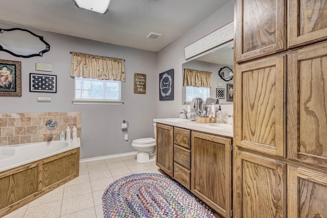 5730 Rendon Estates Rd, Mansfield, TX 76063 - full bathroom featuring tile patterned flooring, double vanity, a garden tub, baseboards, and toilet