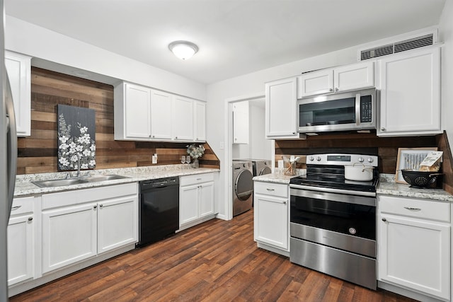 2729 Caton Pl, Abilene, TX 79605 - kitchen featuring appliances with stainless steel finishes, a sink, washing machine and clothes dryer, and white cabinets