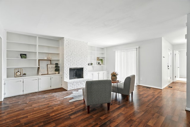 2729 Caton Pl, Abilene, TX 79605 - living room with a fireplace, dark wood finished floors, baseboards, and built in shelves