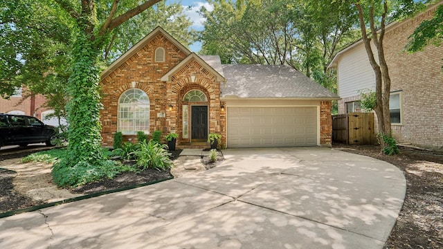 713 N Jordan Rd, Mckinney, TX 75071 - view of front facade with an attached garage, brick siding, concrete driveway, and a gate