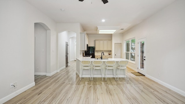 713 N Jordan Rd, Mckinney, TX 75071 - kitchen featuring ceiling fan, freestanding refrigerator, light wood finished floors, a breakfast bar area, and recessed lighting