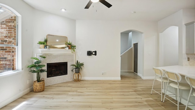 713 N Jordan Rd, Mckinney, TX 75071 - living room with wood finished floors, a ceiling fan, a fireplace, and baseboards