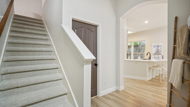713 N Jordan Rd, Mckinney, TX 75071 - stairs featuring wood finished floors, arched walkways, baseboards, and recessed lighting