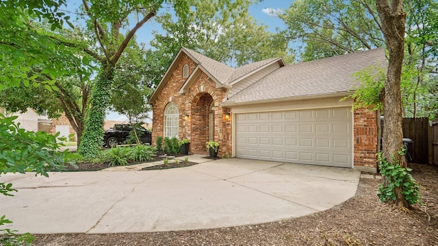 713 N Jordan Rd, Mckinney, TX 75071 - view of front of house featuring driveway, brick siding, an attached garage, and a shingled roof