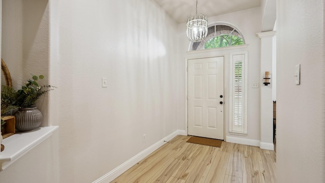 713 N Jordan Rd, Mckinney, TX 75071 - foyer entrance with light wood-type flooring, a chandelier, and baseboards