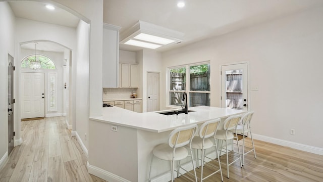713 N Jordan Rd, Mckinney, TX 75071 - kitchen with a sink, light wood-type flooring, arched walkways, light countertops, and recessed lighting