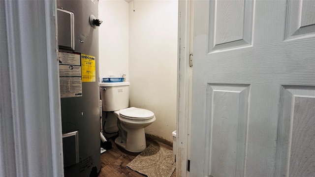 3030 Warren Ave, Dallas, TX 75215 - bathroom with toilet, electric water heater, and wood finished floors