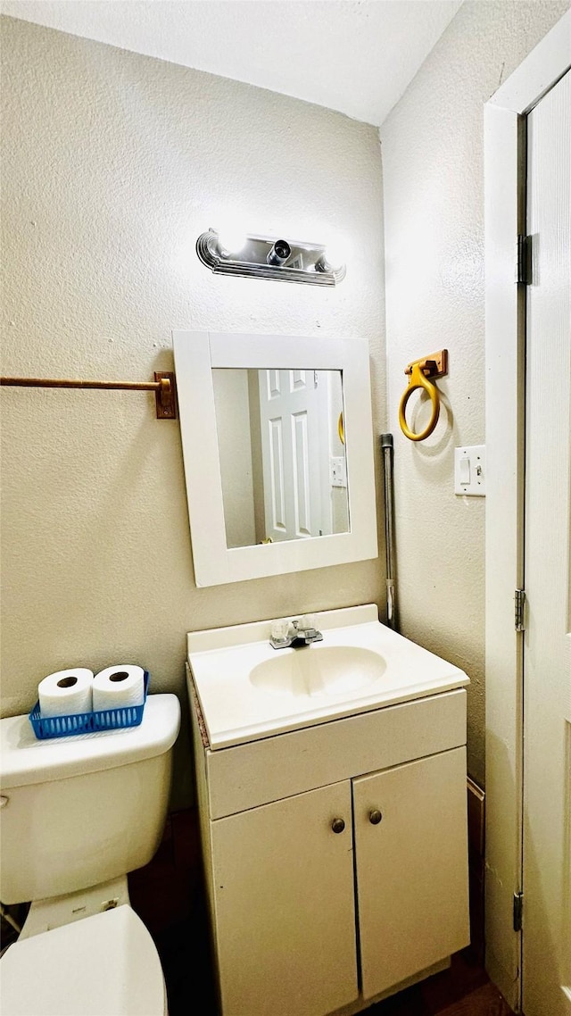 3030 Warren Ave, Dallas, TX 75215 - half bath with vanity, toilet, and a textured wall