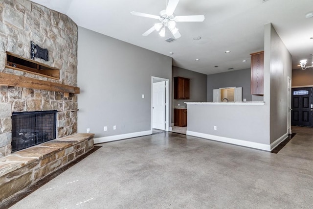 1128 Diablo Pass, Fort Worth, TX 76052 - unfurnished living room with baseboards, finished concrete floors, a stone fireplace, a ceiling fan, and recessed lighting