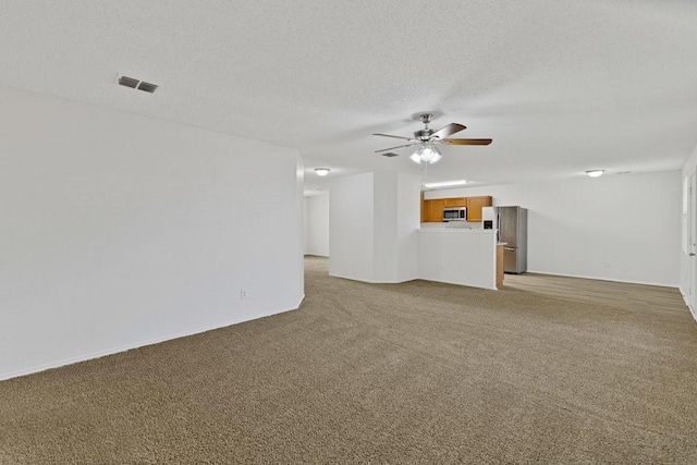 3563 Red Mine Ln, Grand Prairie, TX 75052 - unfurnished living room featuring a ceiling fan, light colored carpet, a textured ceiling, and baseboards