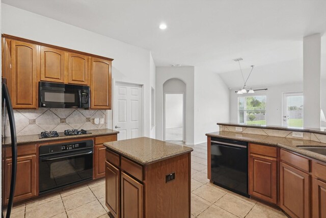 209 Lariat Dr, Fate, TX 75087 - kitchen featuring black appliances, backsplash, a chandelier, light tile patterned floors, and arched walkways