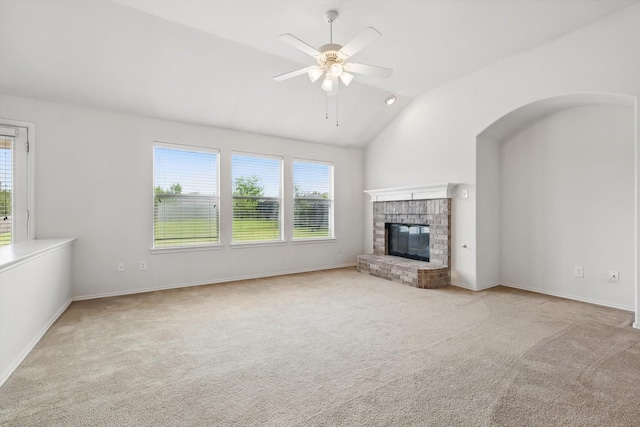 209 Lariat Dr, Fate, TX 75087 - unfurnished living room featuring healthy amount of natural light, carpet floors, a ceiling fan, vaulted ceiling, and a brick fireplace