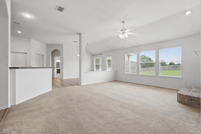 209 Lariat Dr, Fate, TX 75087 - unfurnished living room with a ceiling fan, light colored carpet, arched walkways, recessed lighting, and lofted ceiling
