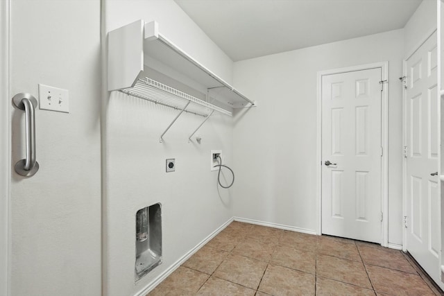 209 Lariat Dr, Fate, TX 75087 - laundry area with hookup for a washing machine, electric dryer hookup, light tile patterned flooring, and baseboards