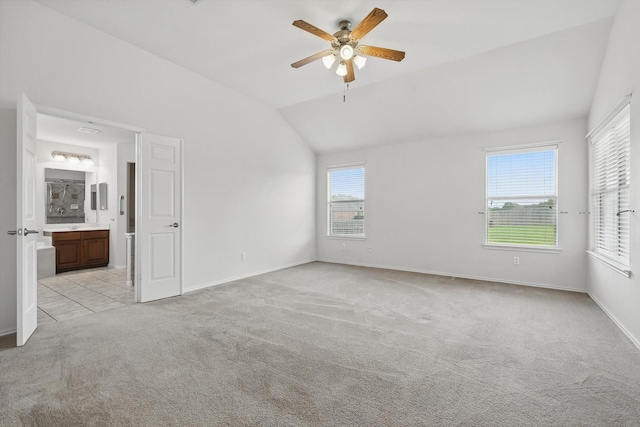 209 Lariat Dr, Fate, TX 75087 - unfurnished bedroom with light colored carpet, vaulted ceiling, ensuite bathroom, baseboards, and ceiling fan